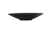 A shallow, wide, black ceramic Nomi Bowl with a slightly ribbed texture and a small circular base, photographed on a plain white background. The bowl's minimalist design gives it a modern and elegant appearance.