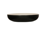 A shallow, round Sophie Pasta Bowl with a matte black melamine exterior and a smooth, light beige interior, photographed against a plain white background. The 16 oz. bowl has clean, modern lines and a low, wide profile.
