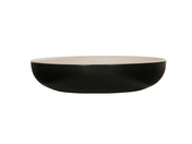 A shallow, round Sophie Pasta Bowl with a matte black melamine exterior and a smooth, light beige interior, photographed against a plain white background. The 16 oz. bowl has clean, modern lines and a low, wide profile.