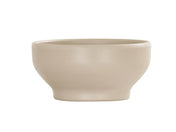 The 16 oz Nova Soup Bowl, in a simple taupe ceramic, features smooth, curved sides and a matte finish. Its wide opening, gently sloping sides, and small raised base create an elegant look on a white background.