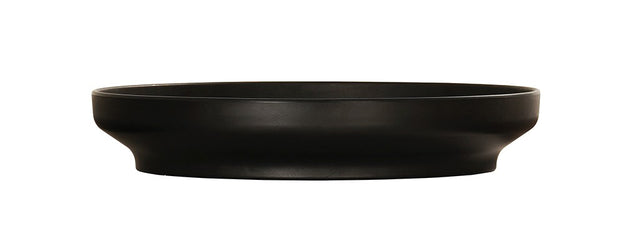 A black Nova Bowl with a modern, shallow coupe design features a wide, flat rim and gently curving sides. The bowl’s matte finish and minimalist style stand out beautifully against the white background.