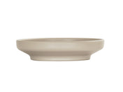 A shallow, round taupe Nova Bowl with a wide coupe rim and smooth matte finish, shown in profile against a plain white background. The bowl has a minimalist design and sits flat on its base.