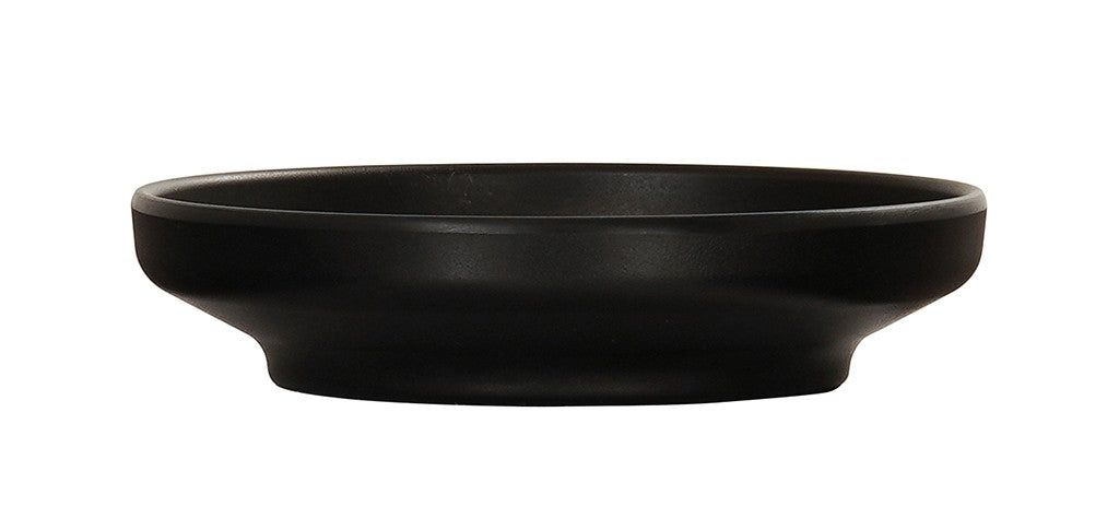 A shallow, round Cal-Mil Nova Bowl in matte black ceramic features a slightly flared rim and wide, flat base. This black bowl showcases a minimalist, modern design with a smooth finish against a white background.