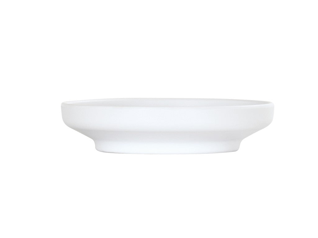 A plain, round, white coupe ceramic plate with a slightly raised rim and a wide, flat base, displayed against a white background. The plate has simple, clean lines and a minimalist design reminiscent of the Nova Bowl or 7" bowl style.
