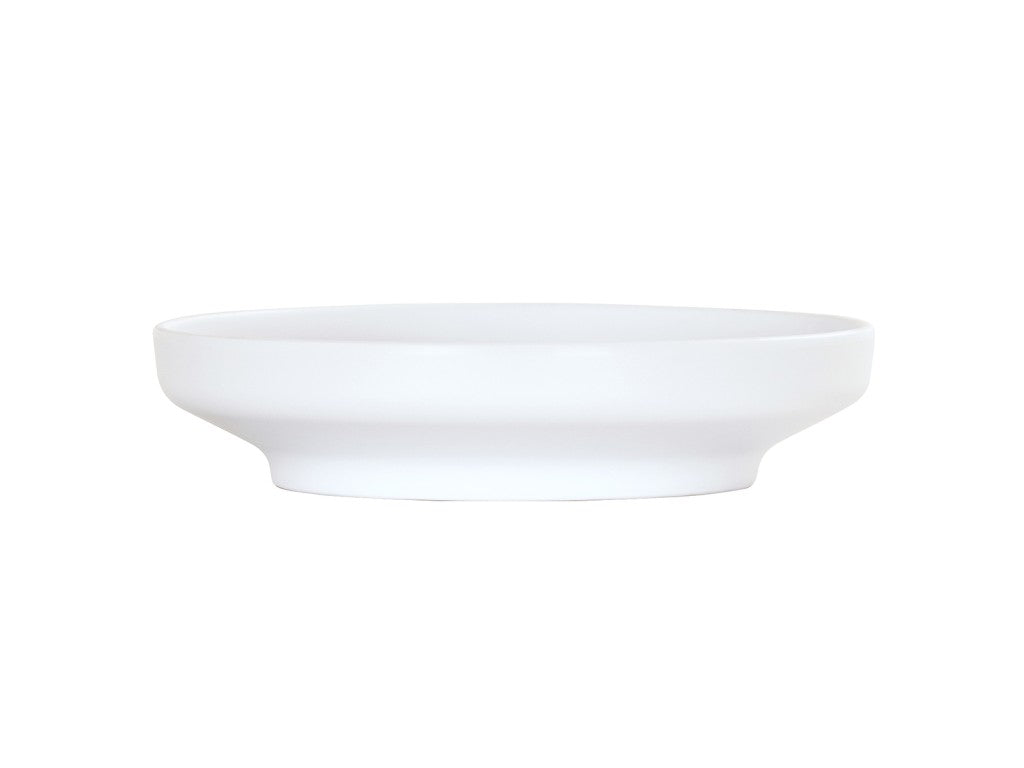 A plain, white Nova Bowl, 9" coupe style, with a wide, shallow shape and gently flared rim sits against a white background. The smooth, minimalist design features no patterns or decorations and has a slightly raised base.