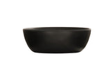 A matte black soup bowl with a smooth, round ceramic form and slightly outward-curved sides is shown empty against a plain white background, highlighting its unadorned, minimalist design.
