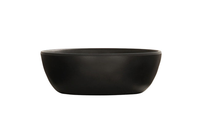 A matte black soup bowl with a smooth, round ceramic form and slightly outward-curved sides is shown empty against a plain white background, highlighting its unadorned, minimalist design.
