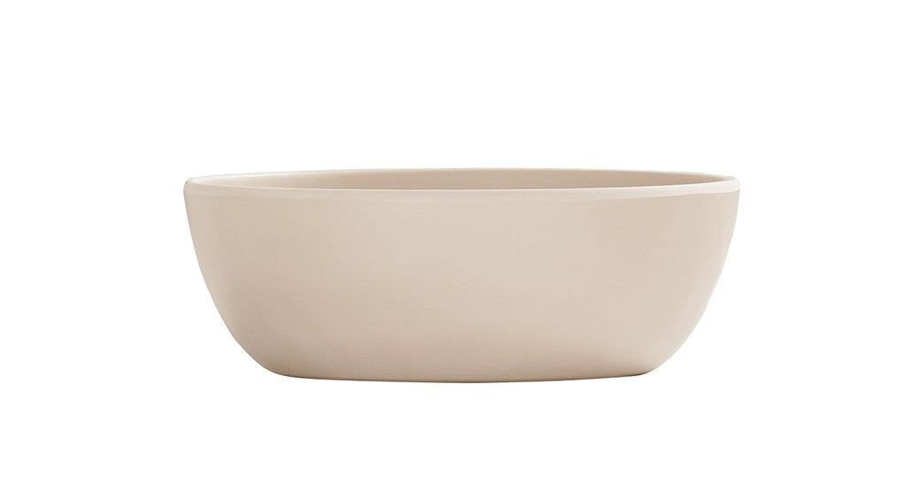 A simple, round, light beige 16 oz soup bowl with smooth sides and a matte finish, shown against a plain white background. The ceramic bowl is empty and features a minimalist, modern design.