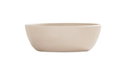 A simple, round, light beige 16 oz soup bowl with smooth sides and a matte finish, shown against a plain white background. The ceramic bowl is empty and features a minimalist, modern design.