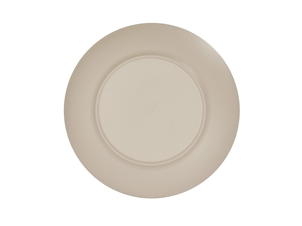 A round, beige Charlotte Bowl seen from above with a smooth, slightly raised center and a wide, textured rim featuring concentric circular grooves. The 14 inch melamine bowl has a matte, unadorned surface with no patterns or decorations.