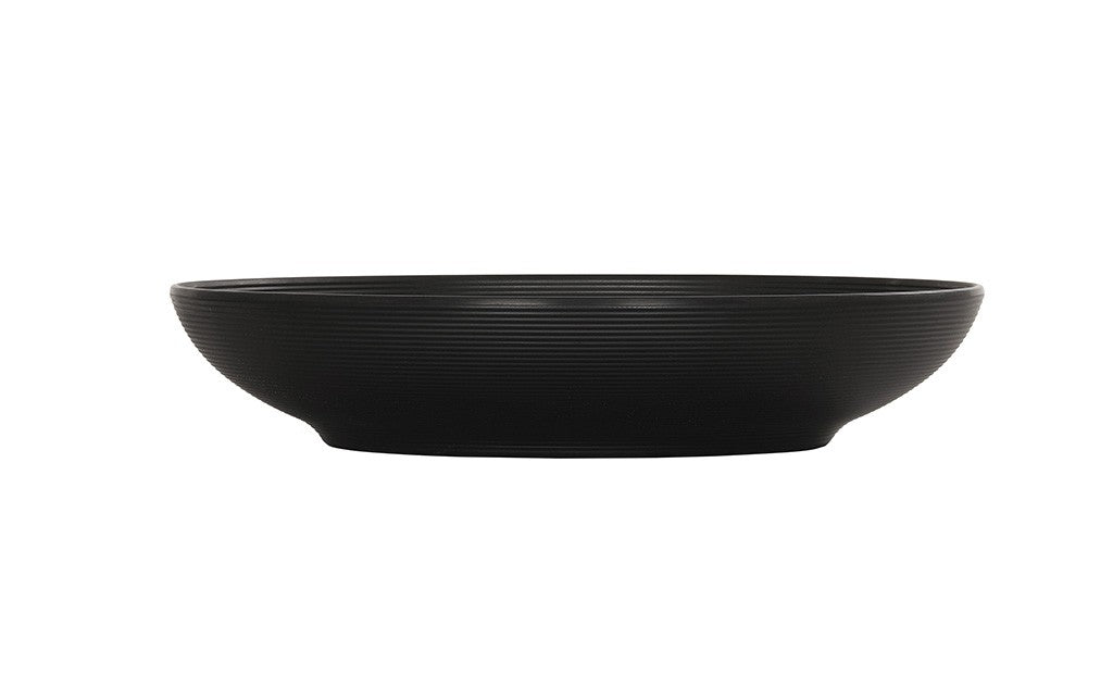 A black Charlotte Bowl with a wide rim and shallow depth, crafted from durable melamine and featuring a subtle horizontal ribbed texture on its exterior. The bowl is photographed against a white background with no visible contents.