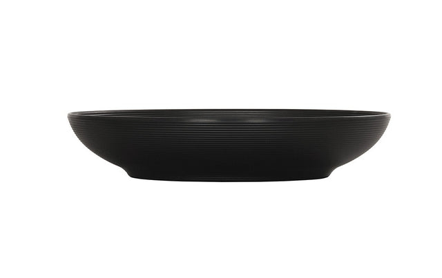 A black Charlotte Bowl with a wide rim and shallow depth, crafted from durable melamine and featuring a subtle horizontal ribbed texture on its exterior. The bowl is photographed against a white background with no visible contents.