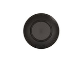 A matte black coupe bowl is shown from above, displaying its circular, ridged design along the rim. The center has indented text with branding and care instructions. The plain white background highlights the Charlotte Bowl’s simple, modern appearance.