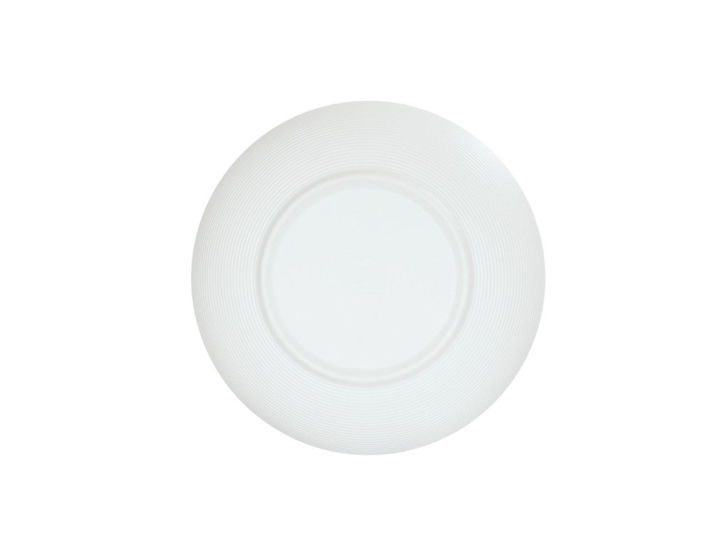 A plain, round white ceramic plate with a slightly textured, concentric ring pattern on the rim, viewed from above against a white background. Reminiscent of the classic Charlotte Bowl style, the plate is empty and centered in the image.