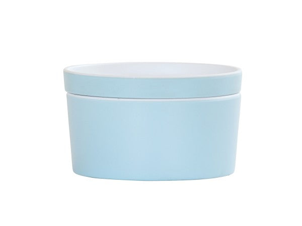 A simple, round, light blue Bento Box with a matching lid. Made from melamine, the container features a smooth surface and minimalistic design, shown against a plain white background.