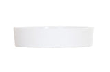 A plain, round, white ceramic dish with straight sides, shown against a white background. Dishwasher safe and easy to clean, the dish is empty and photographed from a side angle, highlighting its minimalist design and smooth surface.