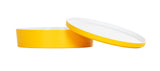 A round, flat, matte yellow melamine container with a matching yellow and white lid. The lid is propped at an angle on the container, showing the white interior. This Bento Box is dishwasher safe. The background is plain white.