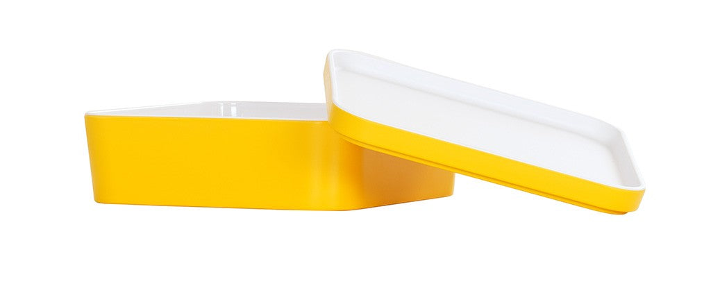 A rectangular bento box with rounded corners, featuring a bright yellow melamine exterior and a white interior. The dishwasher safe lid is propped open, revealing the inside of the yellow base against a plain white background.