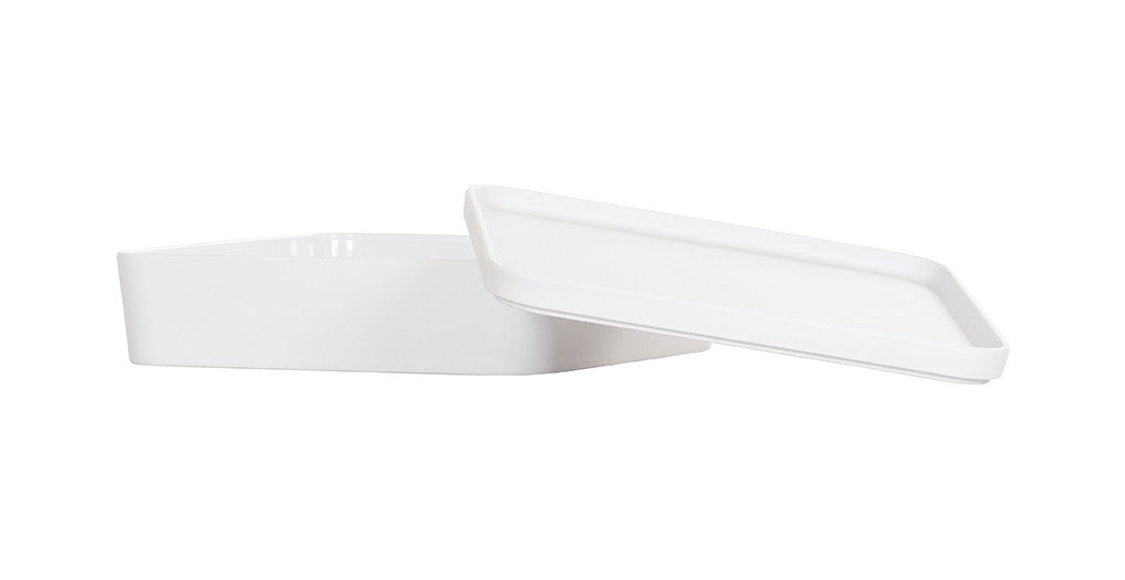 A rectangular white melamine container with slightly rounded edges is shown with its matching flat lid partially lifted and resting at an angle, revealing the empty inside. This Bento Box-style dish is dishwasher safe. The background is plain white.