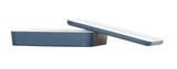 A rectangular, blue ceramic baking dish with a white interior is shown with its matching, dishwasher safe, white-edged blue lid resting diagonally on top, both placed on a plain white background.