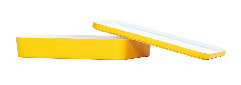 A rectangular, yellow and white melamine dish with a matching lid. The dish is placed horizontally, while the lid is slightly tilted and resting on the edge. Both pieces feature smooth, modern lines and are dishwasher safe against a white background.