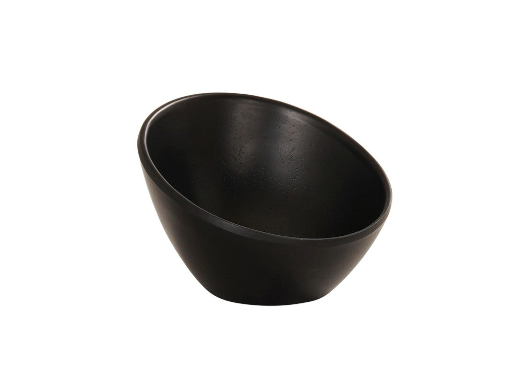 A matte black Cal-Mil bowl with a smooth surface and slightly slanted, asymmetrical rim sits against a plain white background. Its deep, curved interior and clean, modern exterior make this melamine bowl both functional and stylish.