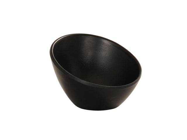 A matte black Cal-Mil bowl with a smooth surface and slightly slanted, asymmetrical rim sits against a plain white background. Its deep, curved interior and clean, modern exterior make this melamine bowl both functional and stylish.