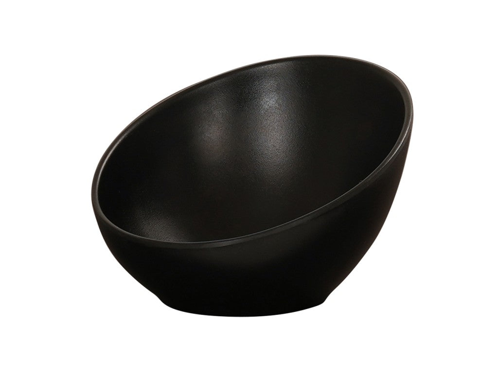 A black, modern Cal-Mil bowl with a smooth matte finish, shown at an angle that highlights its deep, slanted design. The bowl sits on a white background, emphasizing its sleek and minimalist aesthetic.