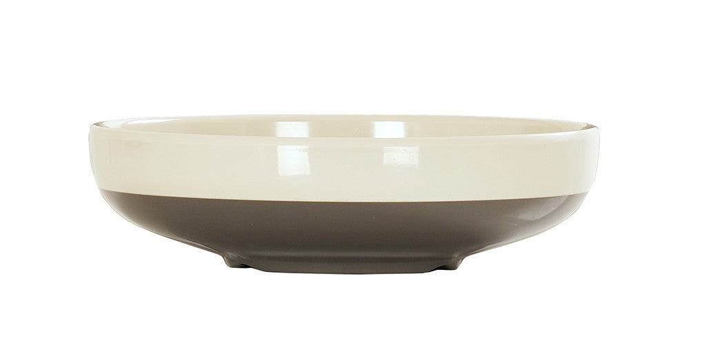 A shallow, round Vienna Bowl with a glossy finish. The upper half is cream-colored, while the lower half is a dark grayish-brown. This ceramic bowl has a smooth rim, rests on a slightly elevated base, and is set against a plain white background.