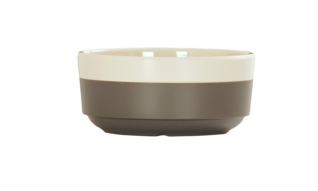 The Vienna Bowl features a simple design with a cream-colored upper half and matte gray lower half. Crafted in ceramic, this bowl has a smooth, round shape and is dishwasher safe, making it both stylish and practical.