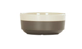 The Vienna Bowl features a simple design with a cream-colored upper half and matte gray lower half. Crafted in ceramic, this bowl has a smooth, round shape and is dishwasher safe, making it both stylish and practical.