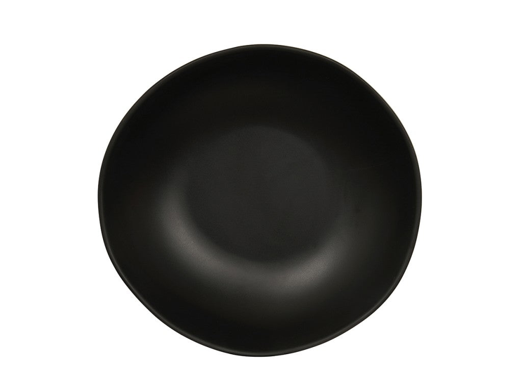 A round, matte black ceramic plate viewed from above. Reminiscent of a Bali Pasta Bowl, it has a smooth, slightly curved surface and subtle, uneven rim for a modern, minimalist look. The background is plain and white.