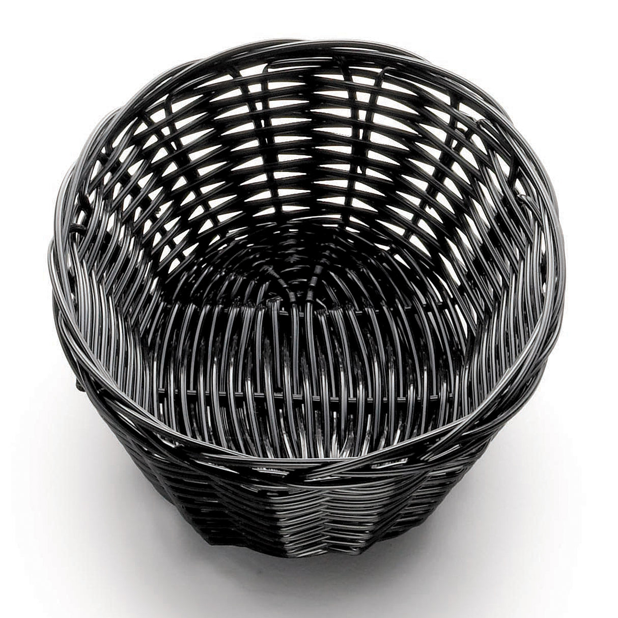 A round, empty, black polypropylene basket sits on a white surface. The hand-woven, sturdy rattan-style material has a smooth, glossy finish and a slightly flared rim. A shadow underneath suggests overhead lighting.