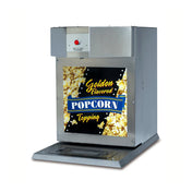 A stainless steel counter model Bag-in-Box Topping Dispenser features a red push button and a colorful Golden Flavored Popcorn Topping sign above an image of popcorn. It has a flat base with a black drip grate at the bottom.