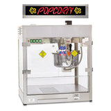 The Discovery 32 oz. Popcorn Popper features a stainless steel cabinet with glass sides and an interior kettle for popping corn. Above, a black sign displays neon-style red POPCORN text flanked by two yellow popcorn kernel designs.