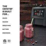 A commercial blender with a 4 liter stainless steel container sits on a dark wooden surface beside two mason jar glasses filled with pink smoothies, topped with blueberries and a striped straw. Text at left lists uses: soups, sauces, smoothies, batters, dressings.