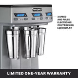 A triple spindle silver Waring Drink Mixer with three stainless steel cups, each beneath its own LCD control panel. The display shows times and buttons for speed and pulse. Features automatic cup-activated operation and a limited one-year warranty.