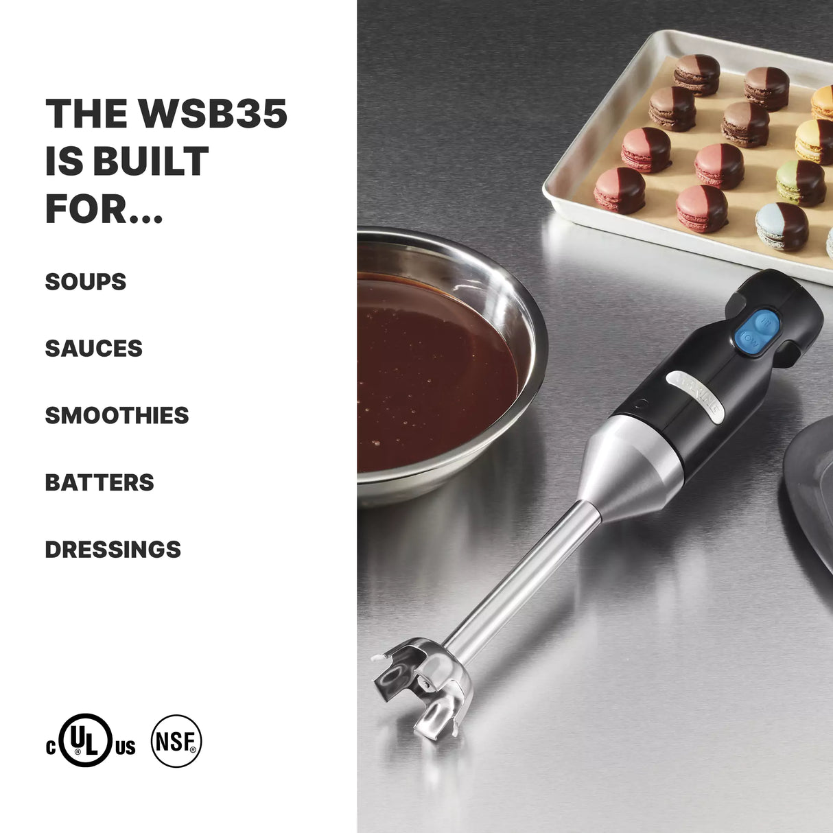 A black and silver immersion blender with a stainless steel shaft lies on a stainless steel counter near a bowl of melted chocolate and a tray of colorful macarons. Text on the left lists foods this light duty blender is built for, including soups, sauces, smoothies, batters, and dressings.