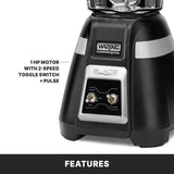 Close-up of a black Waring Commercial Blade Bar Blender base with metal control panel, OFF, HIGH, LOW, and PULSE toggle switches. Features a 1 HP motor, 2-speed toggle switch, pulse function, and is compatible with a 48-oz. plastic container. FEATURES below.