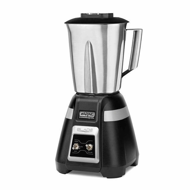 A commercial-grade bar blender with a tall stainless steel container, sturdy black base, silver accents, two toggle switches labeled OFF, ON, and PULSE, and the brand Waring Commercial displayed on the front. Ideal for international use.
