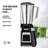 A Waring Commercial 2-speed Blade Bar Blender with a stainless steel container sits on a countertop beside two green smoothies, with leafy greens nearby. Text reads, THE BB340S IS BUILT FOR... blended cocktails, mocktails, smoothies. NSF and safety icons are below.