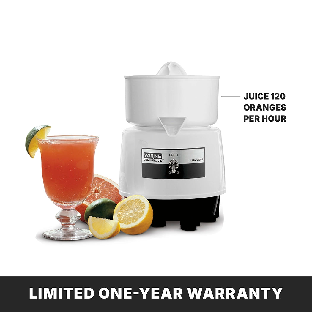 A white Bar juicer labeled “JUICE 120 ORANGES PER HOUR” sits beside a glass of orange juice garnished with lime, half an orange, lemon, and lime, all on a white background. Below, bold text reads, “LIMITED ONE-YEAR WARRANTY.”.