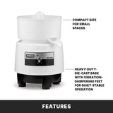 A white electric Bar juicer with a compact design. Arrows highlight its small size for limited spaces and a sturdy die-cast base with vibration-dampening feet for quiet, stable operation. The black control switch is visible on the front. “FEATURES” is written below.