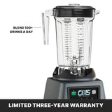 A commercial heavy-duty blender with a clear, marked pitcher and black lid is shown. Text on the image reads “BLEND 100+ DRINKS A DAY.” The base displays “CB15 The Legend.” A banner at the bottom states, “LIMITED THREE-YEAR WARRANTY.”.
