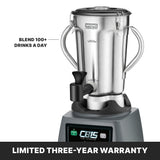 A heavy-duty blender with sturdy handles and a stainless steel container sits on a gray base featuring a digital display reading CB15 The Legend. Text beside it reads, Blend 100+ drinks a day. Bottom banner states, Limited three-year warranty.