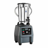 A 4 liter commercial blender with a stainless steel container and two side handles sits on a sturdy black base. The base features buttons, switches, and a dial labeled with various settings. The lid displays a warning label.