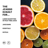 A colorful assortment of sliced citrus fruits, including oranges, lemons, limes, and grapefruit, is arranged on the right. On the left, text reads: “The heavy duty electric JC4000 juicer is built for large quantities of pulp-free juice: juice bars, hospitals, hotels.” NSF and certification logos below.