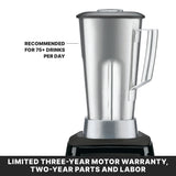 A high-power, 64 oz stainless steel blender with a lid sits atop a black base. Text on the left reads “Recommended for 75+ drinks per day.” A bold banner at the bottom states, “Limited three-year motor warranty, two-year parts and labor.”.