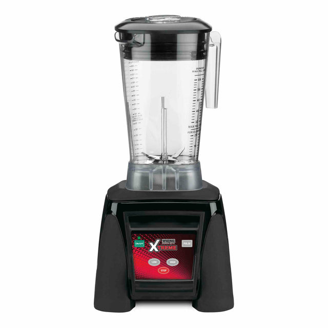 A countertop Xtreme Series Blender with a clear plastic jar, lid, and handle sits atop a black base. The red panel is labeled Xtreme with digital display buttons, including start and stop. This 3.5 HP blender features measurement markings on the jar.