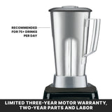 A high-power blender with a 64 oz. stainless steel container on a sleek black base and a secure lid. Text reads: RECOMMENDED FOR 75+ DRINKS PER DAY. Below, a black banner states: LIMITED THREE-YEAR MOTOR WARRANTY, TWO-YEAR PARTS AND LABOR.